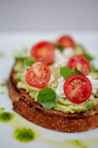 Employee handing sandwich and chips